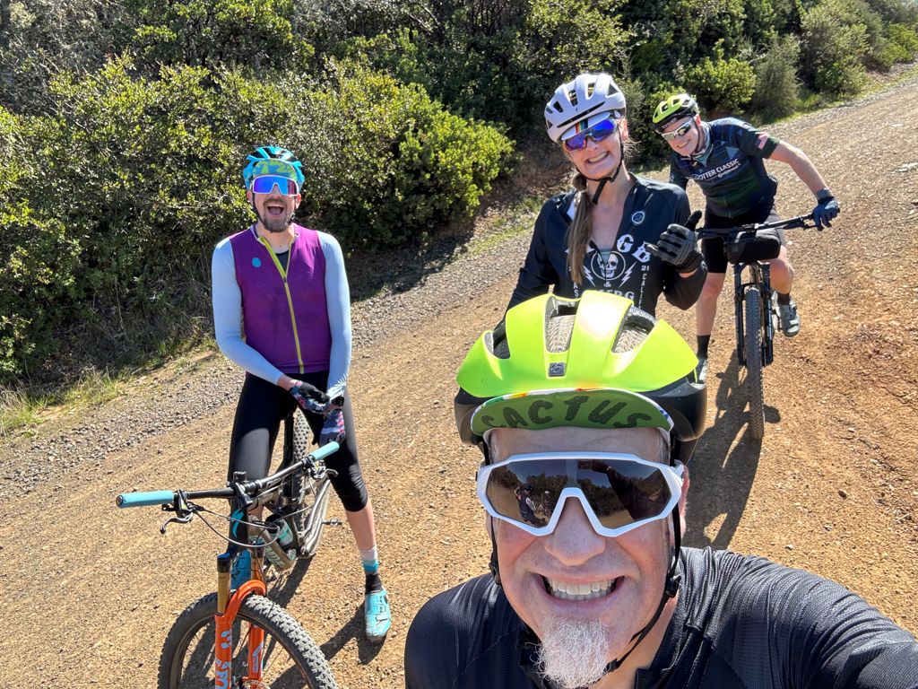 four bikers, top of climb