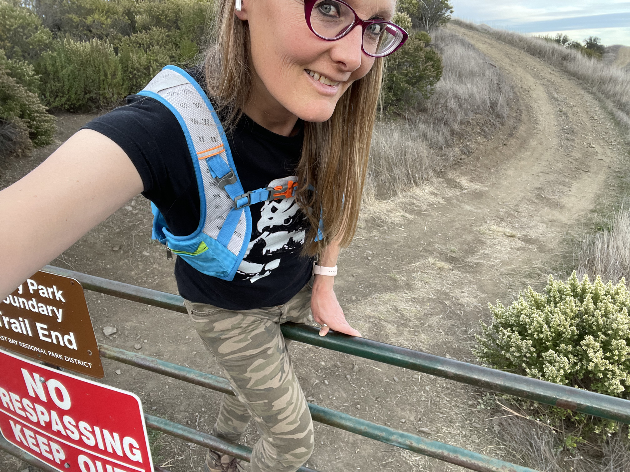 tracey climbing over KEEP OUT gate