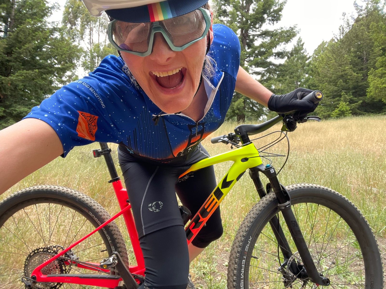 tracey on new mountain bike in field