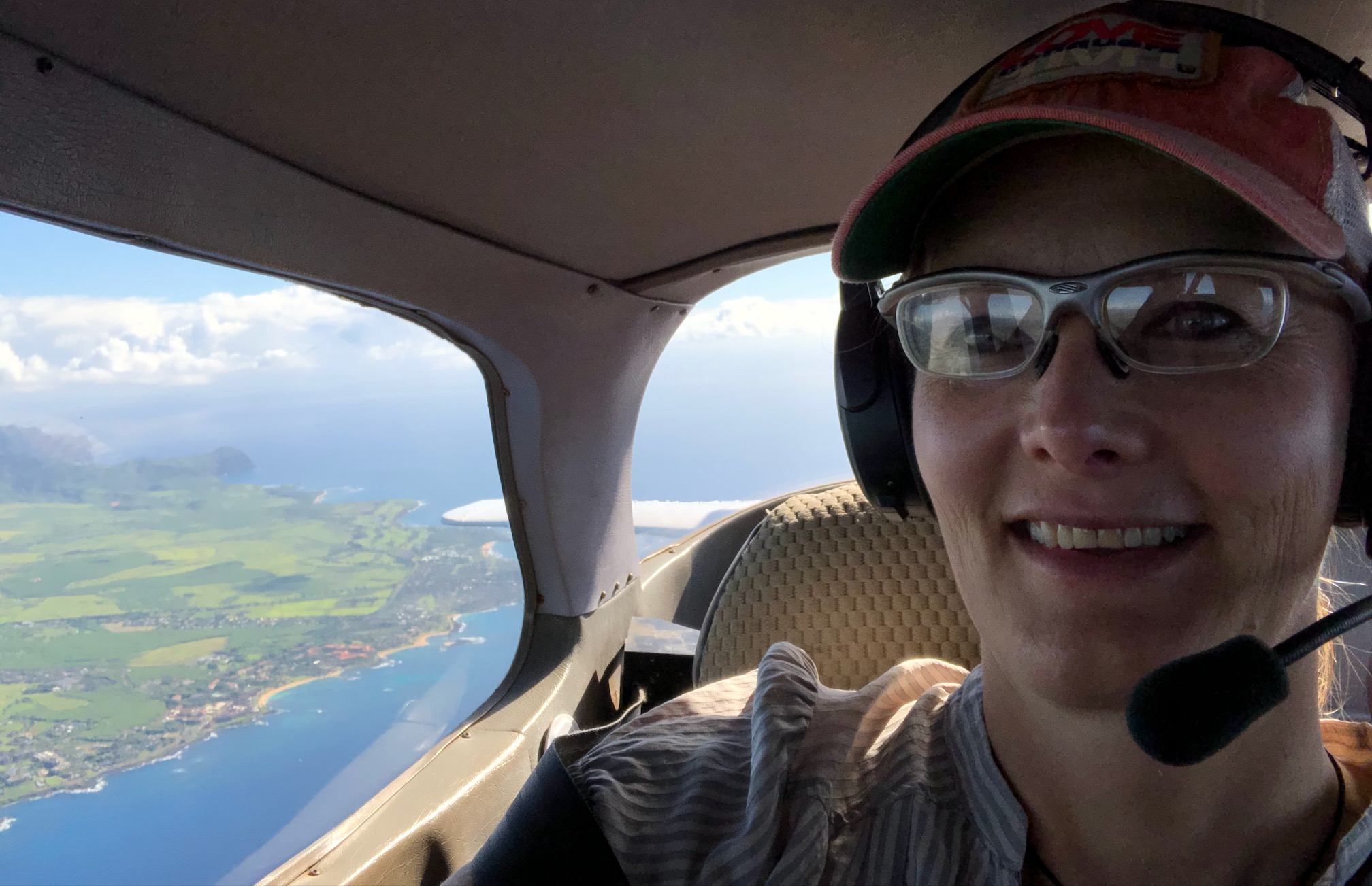 tracey in plane back seat over coast