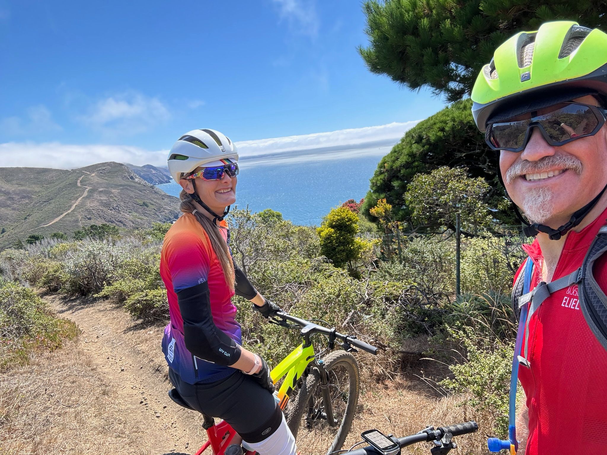 hunter and tracey on bikes overlooking Muir Beach