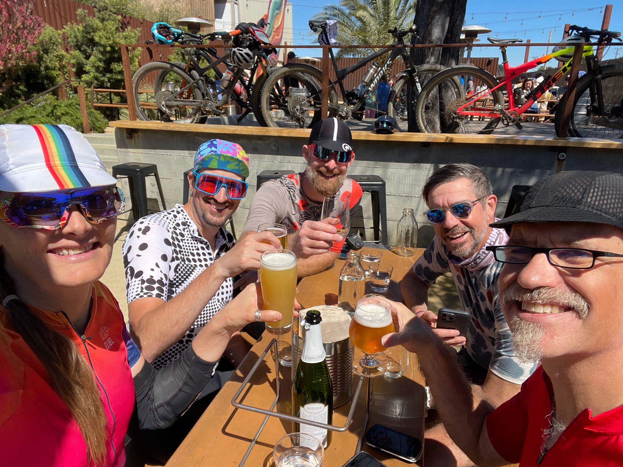 all 5 of the bikers sharing a drink